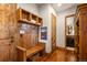 Traditional mudroom featuring wood bench, built-in shelving, and hardwood floors at 9617 S Shadow Hill Cir, Lone Tree, CO 80124