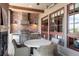 Outdoor kitchen with a built-in grill, brick accents, and a dining area at 9617 S Shadow Hill Cir, Lone Tree, CO 80124