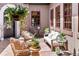 Cozy outdoor seating area featuring wicker chairs, a white sofa, plants, and decorative hanging basket at 9617 S Shadow Hill Cir, Lone Tree, CO 80124