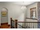 Bright foyer with decorative chandelier, hardwood floors, and a wood-trimmed staircase at 9617 S Shadow Hill Cir, Lone Tree, CO 80124