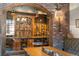 Built-in wine storage niche with wood and metal racks, displayed bottles, and ambient lighting at 9617 S Shadow Hill Cir, Lone Tree, CO 80124