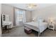 Cozy bedroom with a decorative metal frame bed, vanity, and a window with natural light at 15777 E 13Th Pl, Aurora, CO 80011