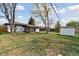 Spacious backyard with well-maintained lawn and a shed at 2840 Cottonwood Dr, Denver, CO 80221