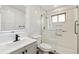 Modern bathroom with white subway tile, a glass-enclosed shower, and updated fixtures at 2840 Cottonwood Dr, Denver, CO 80221