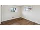 Bright bedroom with hardwood floors, white walls, and natural light from the window at 2840 Cottonwood Dr, Denver, CO 80221