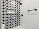 Nicely tiled shower showcasing star patterned accent wall and matte black hardware at 2840 Cottonwood Dr, Denver, CO 80221