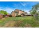 Spacious backyard featuring a well-maintained lawn with view of patio and the home's exterior at 2954 E 101St Ave, Thornton, CO 80229