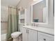 Bathroom featuring a shower, sink, cabinet, and shelving over the toilet at 2954 E 101St Ave, Thornton, CO 80229