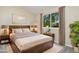 Bedroom featuring a large window, hardwood furniture and minimalist decor at 2954 E 101St Ave, Thornton, CO 80229