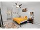 Vaulted ceiling bedroom featuring a ceiling fan, carpet floors, and an ensuite bathroom at 2954 E 101St Ave, Thornton, CO 80229