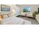 Bright bedroom with white furnishings, decorative pillows, and a view from the large window at 2954 E 101St Ave, Thornton, CO 80229
