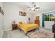 Bright bedroom with vaulted ceiling, ceiling fan, plush carpet, and large window at 2954 E 101St Ave, Thornton, CO 80229