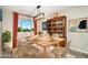 Staged dining room featuring a light wooden table and a unique wooden cabinet at 2954 E 101St Ave, Thornton, CO 80229