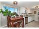 Bright kitchen with a dining area and lots of natural light from the large window at 2954 E 101St Ave, Thornton, CO 80229