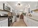 Well-lit kitchen with stainless steel appliances, granite countertops, and ample cabinet space at 2954 E 101St Ave, Thornton, CO 80229