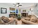 Cozy living room with stone fireplace, plush seating, ceiling fan, and tasteful decor at 2954 E 101St Ave, Thornton, CO 80229