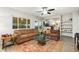 Comfortable living room features ample seating, a glass coffee table, and backyard views at 2954 E 101St Ave, Thornton, CO 80229