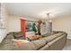 Comfortable living room with a large sectional sofa and plenty of natural light at 2954 E 101St Ave, Thornton, CO 80229