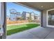 View of a well-maintained backyard and neighboring houses from a covered patio area at 4672 Basalt Ridge Cir, Castle Rock, CO 80108