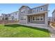 Spacious backyard with healthy green lawn and modern gray home exterior at 4672 Basalt Ridge Cir, Castle Rock, CO 80108