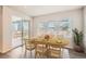 Bright dining room with a wooden table, seating for six, and sliding door access to the backyard at 4672 Basalt Ridge Cir, Castle Rock, CO 80108