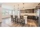 Modern kitchen with an island, pendant lights, and views of the outdoor scenery from large windows at 4672 Basalt Ridge Cir, Castle Rock, CO 80108