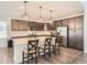 Modern kitchen featuring stainless steel appliances, a spacious island, and stylish pendant lighting at 4672 Basalt Ridge Cir, Castle Rock, CO 80108