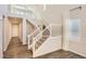 Elegant staircase featuring white railings and plush carpeting, leading to the upper level of the home at 4672 Basalt Ridge Cir, Castle Rock, CO 80108