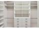 Organized walk-in closet with shelving and drawers for storage solutions at 4672 Basalt Ridge Cir, Castle Rock, CO 80108