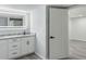 Contemporary bathroom with a double vanity, modern lighting, and a glimpse into the shower at 1345 Holly St, Denver, CO 80220