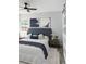 Stylish bedroom featuring a padded headboard, contemporary artwork, and a ceiling fan at 1345 Holly St, Denver, CO 80220