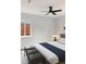Neutral bedroom featuring a ceiling fan, window, and a comfortable bed with stylish throw pillows at 1345 Holly St, Denver, CO 80220