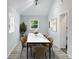 Bright dining room with modern decor, vaulted ceiling, new lights, and natural light at 1345 Holly St, Denver, CO 80220