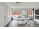 Bright living room featuring a fireplace, modern decor, ample natural light, and stylish furnishings at 1345 Holly St, Denver, CO 80220