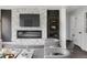 Modern living room with a sleek fireplace feature wall, contemporary furnishings, and neutral tones at 1345 Holly St, Denver, CO 80220
