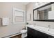 Bright bathroom featuring a modern vanity with double sinks, toilet, and large mirror at 3311 N York St, Denver, CO 80205