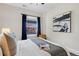 Bright bedroom featuring window with colorful tree view, modern art and a sitting chair at 3311 N York St, Denver, CO 80205