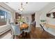 Elegant dining room with a round wooden table and hardwood floors, bathed in natural light at 3311 N York St, Denver, CO 80205