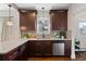 Well-lit kitchen features wooden cabinets, stainless steel dishwasher, and granite countertops at 3311 N York St, Denver, CO 80205