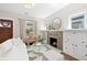 Bright living room with a fireplace, stylish decor, and a view to the outside at 3311 N York St, Denver, CO 80205