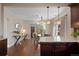 Open concept living room with hardwood floors, dining area, and access to other rooms at 3311 N York St, Denver, CO 80205