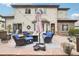 Cozy outdoor lounge area with wicker seating, an umbrella, and stylish patio on a stone floor at 1474 S Uinta Ct, Denver, CO 80231