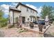 Spacious backyard with stone patio and outdoor seating, perfect for entertaining guests at 1474 S Uinta Ct, Denver, CO 80231