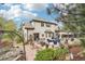 An elevated view of a spacious backyard with stone patio and outdoor seating with lush landscaping at 1474 S Uinta Ct, Denver, CO 80231