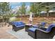 A backyard patio with outdoor seating and mature trees, ideal for relaxation or social gatherings at 1474 S Uinta Ct, Denver, CO 80231