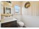 Chic powder room with stylish wallpaper, mirror, and vessel sink at 1474 S Uinta Ct, Denver, CO 80231