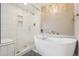 This bathroom showcases a soaking tub, glass enclosed shower and elegant lighting at 1474 S Uinta Ct, Denver, CO 80231