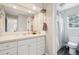 Well-lit bathroom with vanity, sink, and toilet along with the combination shower and tub at 1474 S Uinta Ct, Denver, CO 80231
