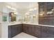 A stunning bathroom with dual sinks, expansive mirrors, and ample cabinet space at 1474 S Uinta Ct, Denver, CO 80231