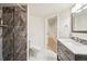 Modern bathroom featuring a sleek vanity, a toilet, a shower with tile accents and neutral tones at 1474 S Uinta Ct, Denver, CO 80231